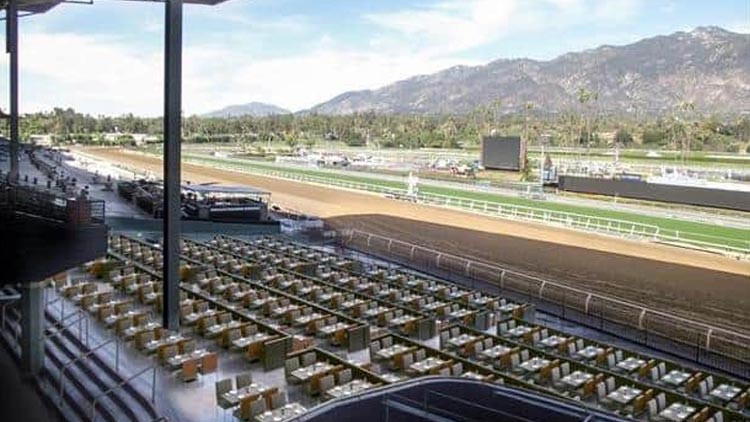 Santa Anita Park race track with grandstand and scenic mountains in the background